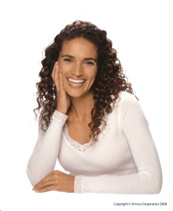 Photo of confident, smiling woman with dental braces