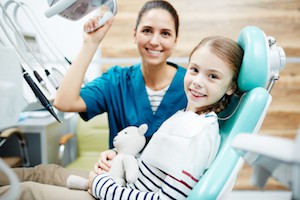 Photo of girl and female dentist at a routine check-up